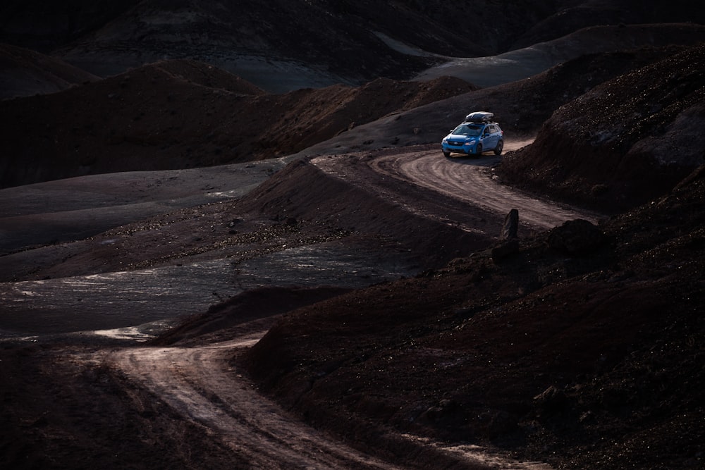 blue car on zig zag road