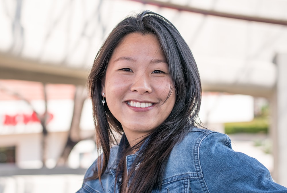 woman smiling wearing blue denim jacket