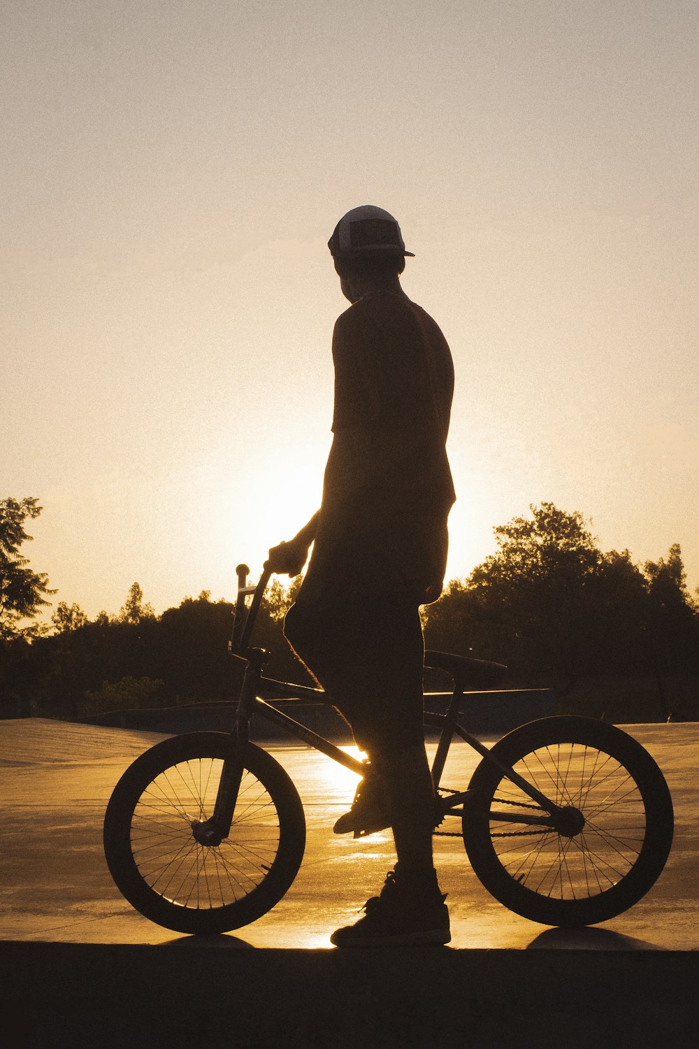 silhouette of man riding on bike