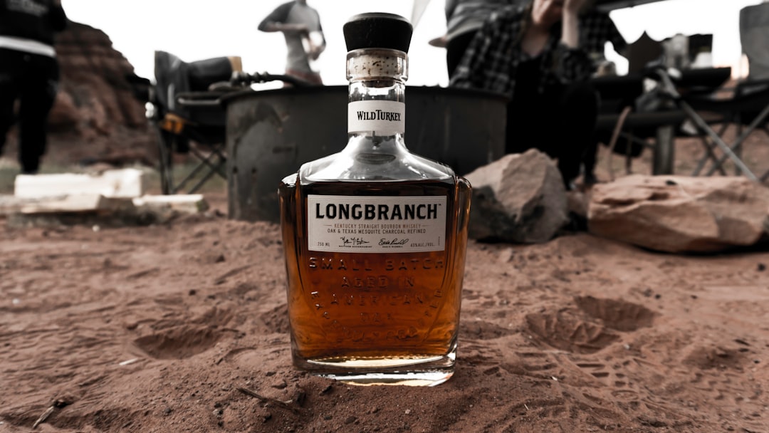 Longbranch bottle on sandy surface