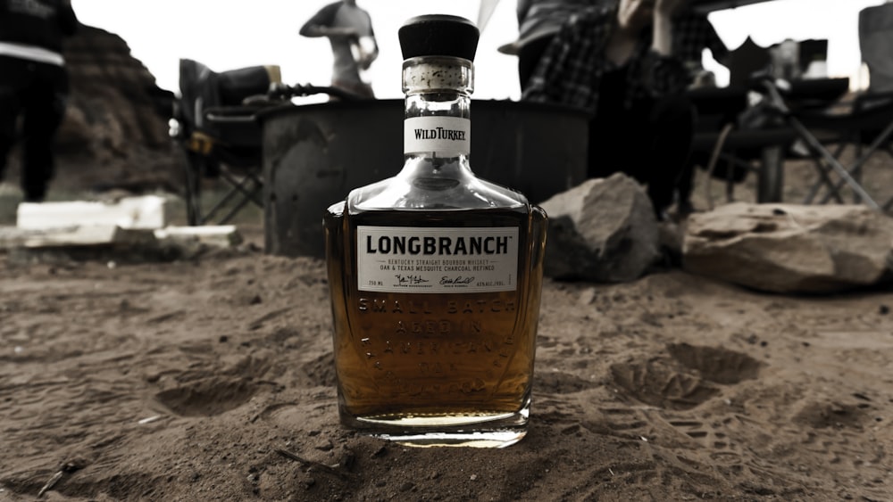 Longbranch bottle on sandy surface