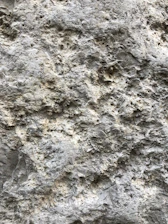 Close-up of a rugged stone surface being precisely measured by digital instruments.