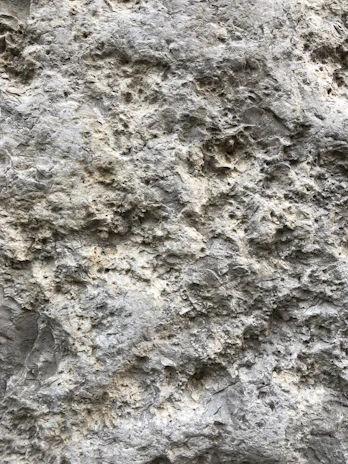 Close-up of a rugged stone surface being precisely measured by digital instruments.