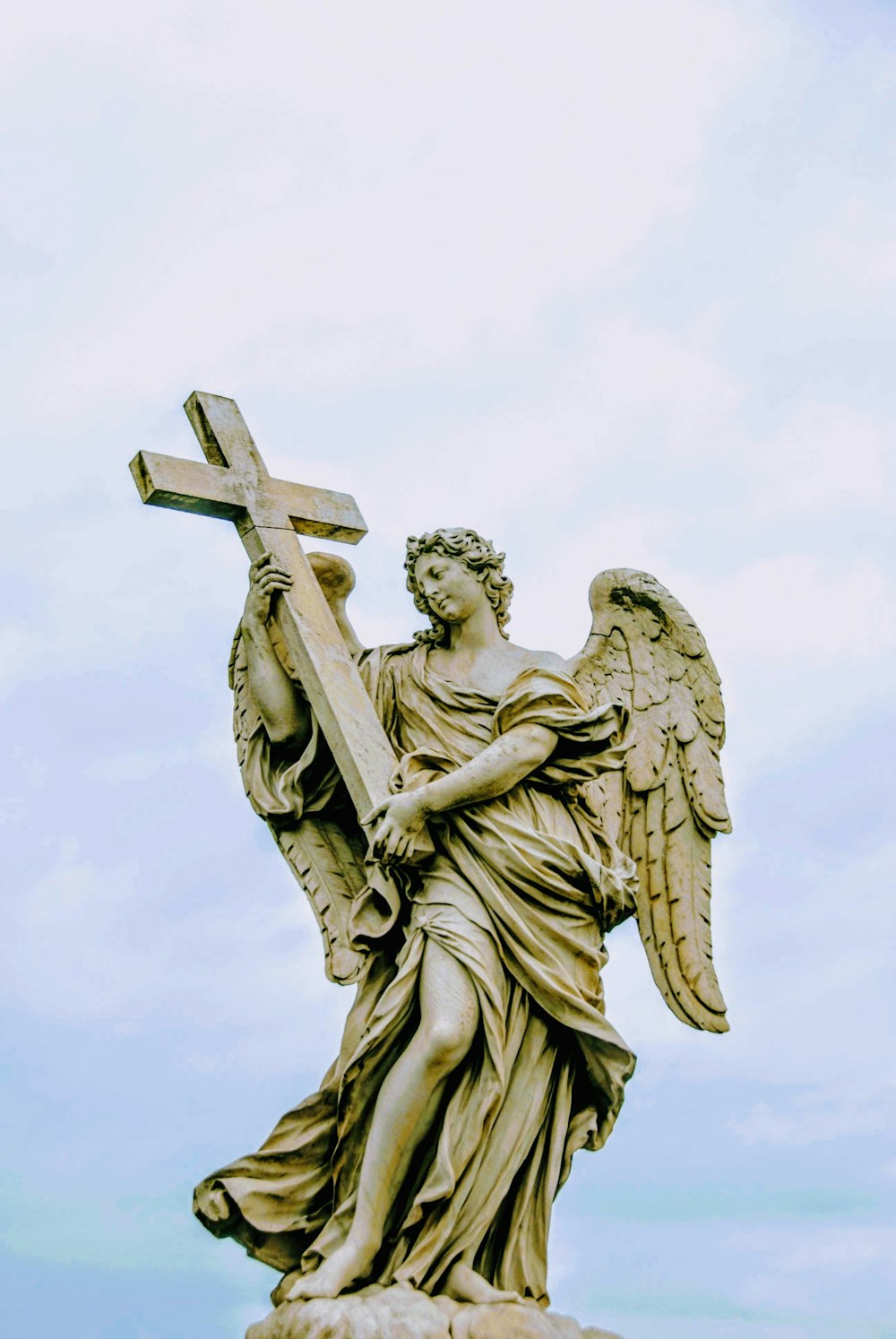 angel carrying cross statue