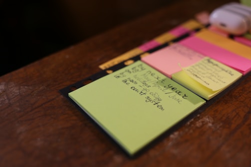green sticky note on brown surface