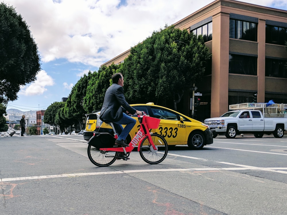 man riding bicycle passing by road