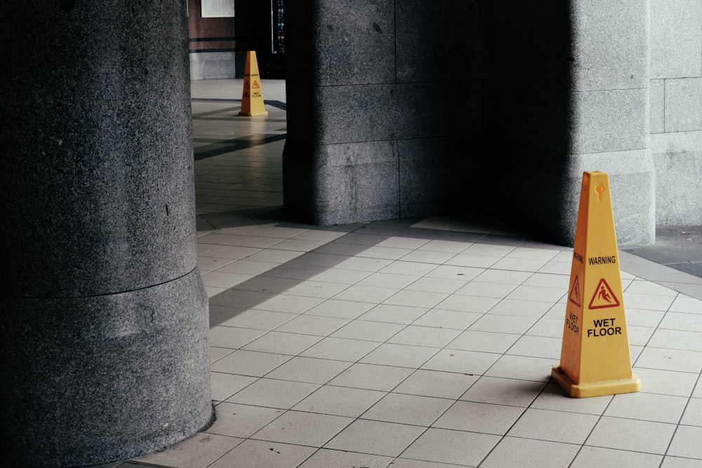 wet floor signage cone on tile floor