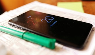 A business owner checking messages on a smartphone late at night.