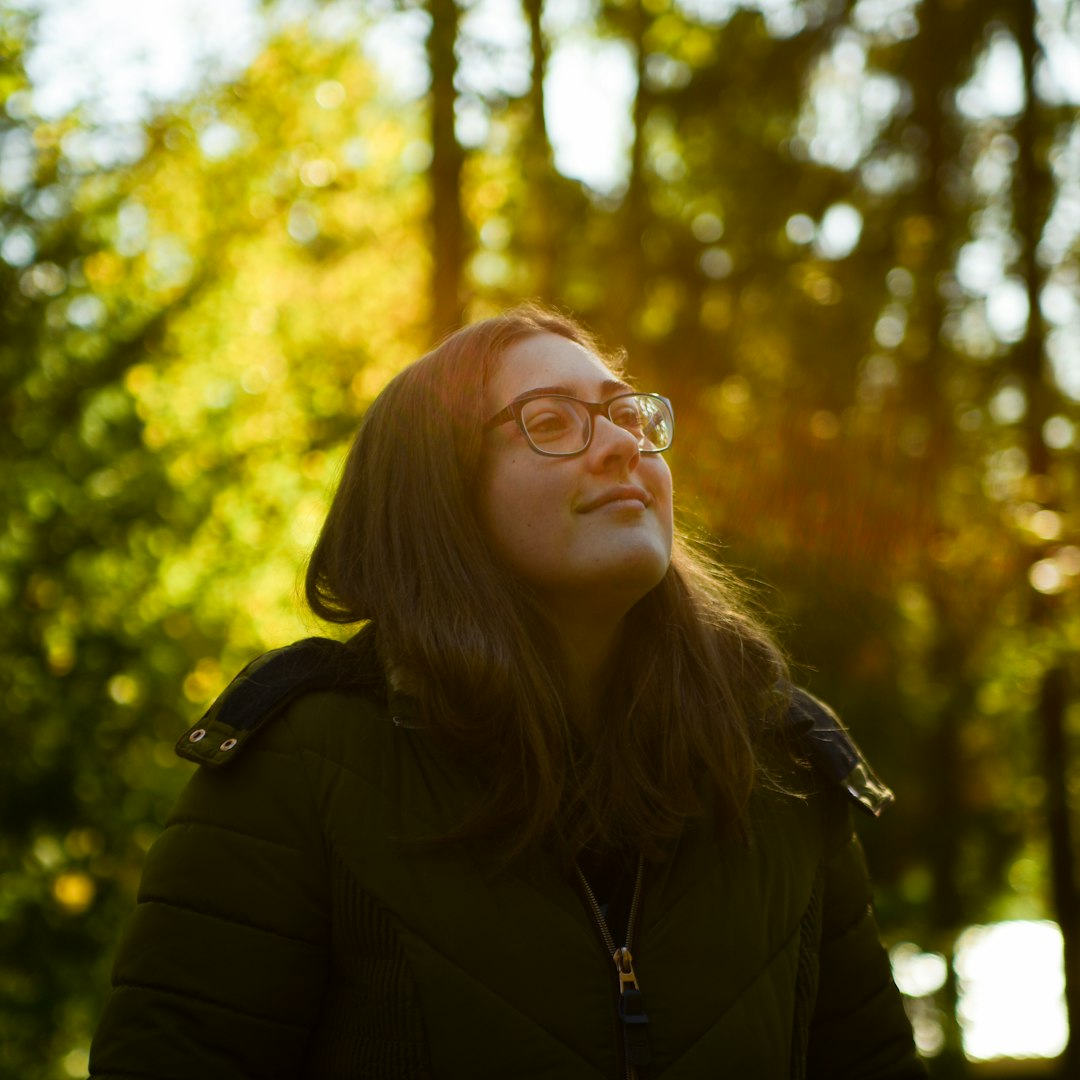 woman wearing eyeglasses and bubble jacket