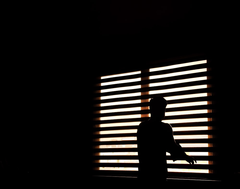 man standing near window