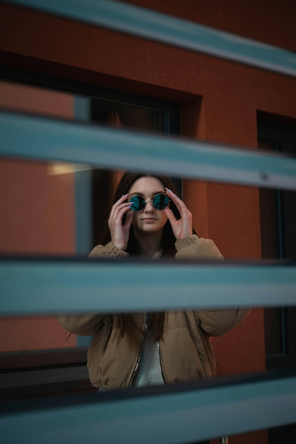 woman holding her sunglasses