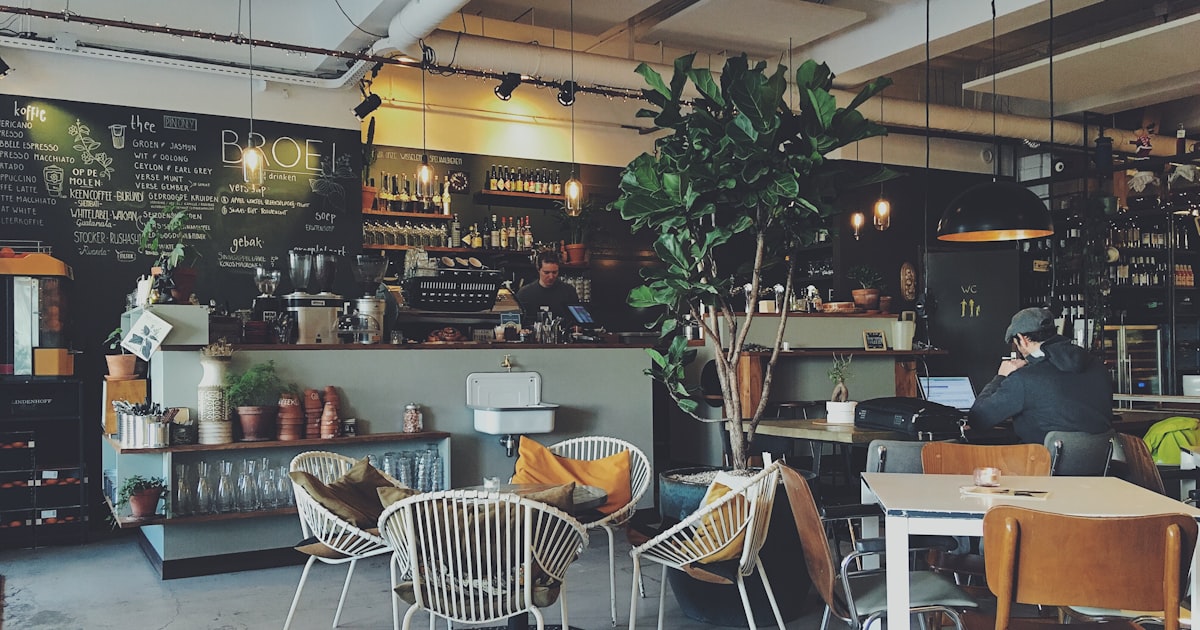 A cozy specialty coffee shop interior in Madrid with warm lighting