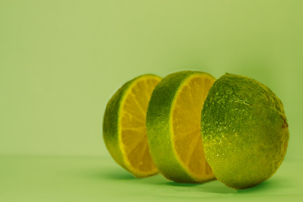 sliced lime on green surface