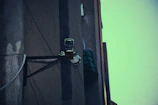 A discreet surveillance camera mounted on a building corner at dusk.