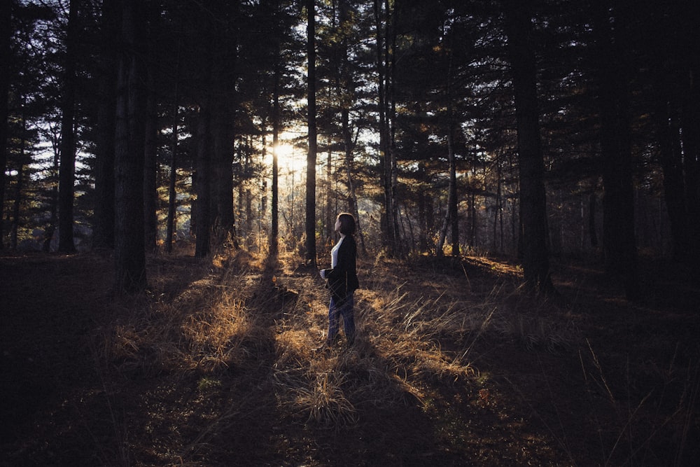 woman standing in forest