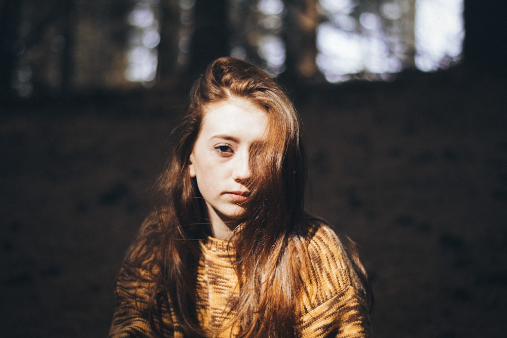 woman wearing brown crew-neck long-sleeved shirt