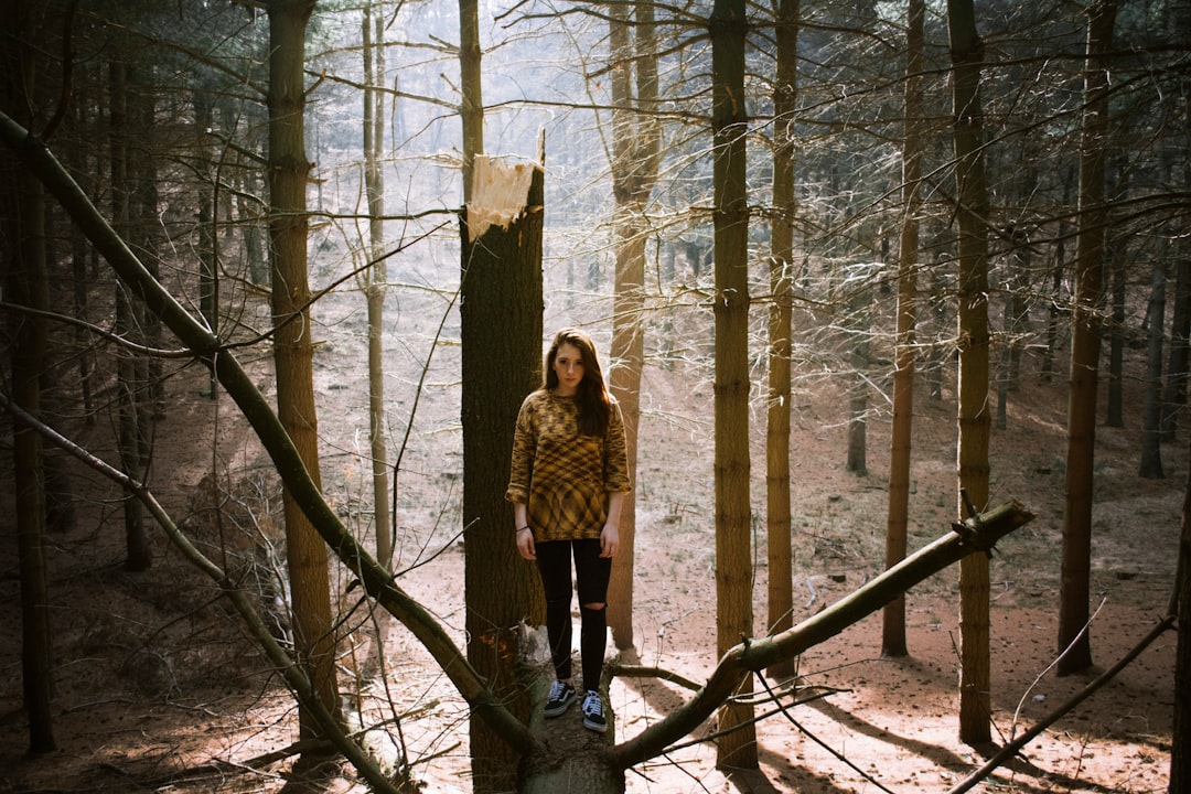 woman standing on tree trunk