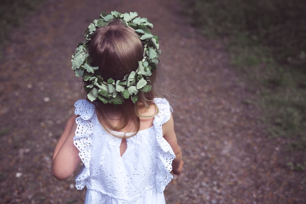 girl in white tank dress with green leaf crown
