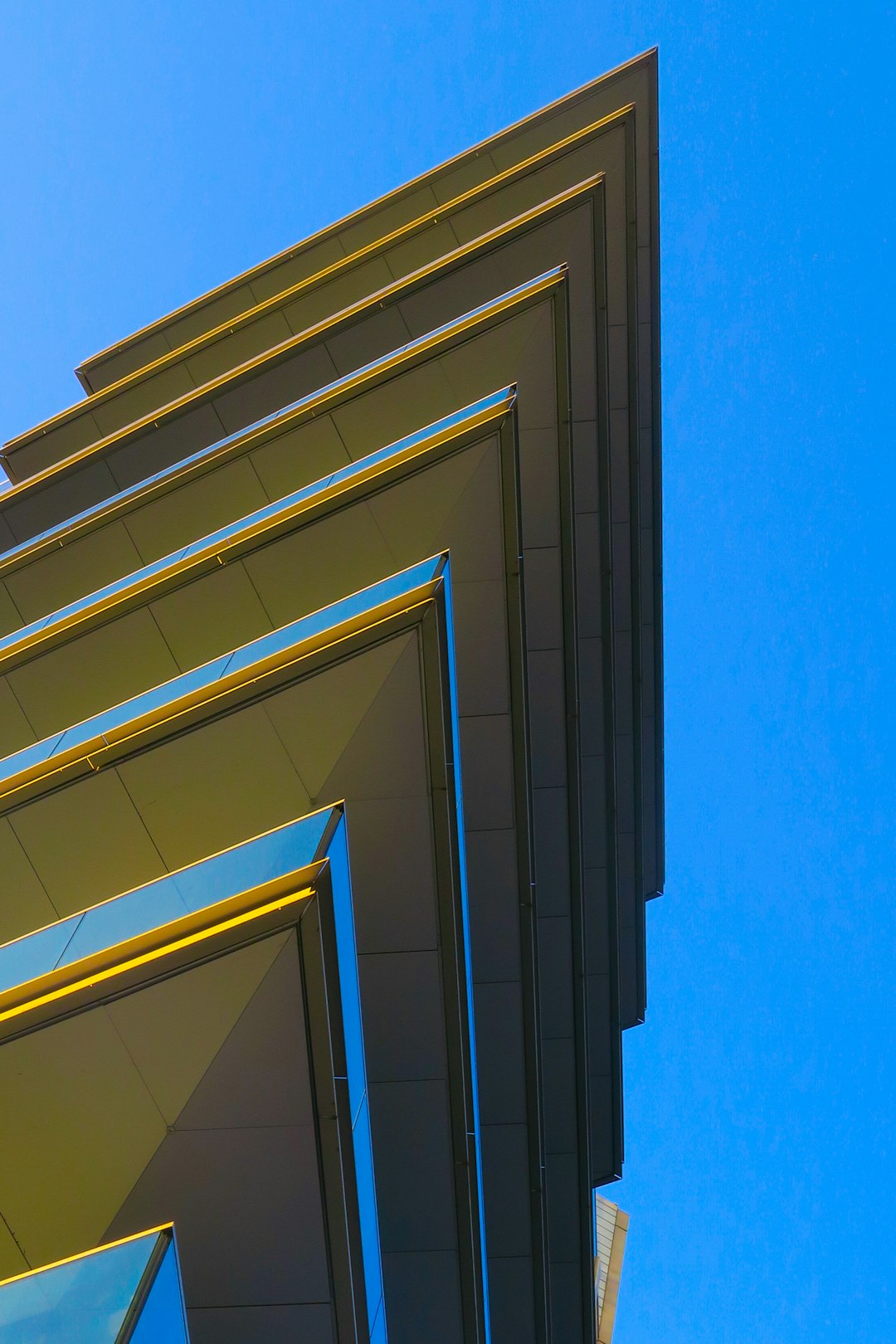 low-angle photography of yellow glass building