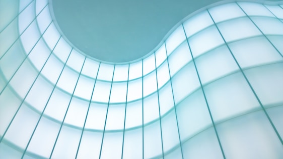 A sleek modern office partition featuring Lumenex’s PDLC smart switchable film glowing softly in natural light.