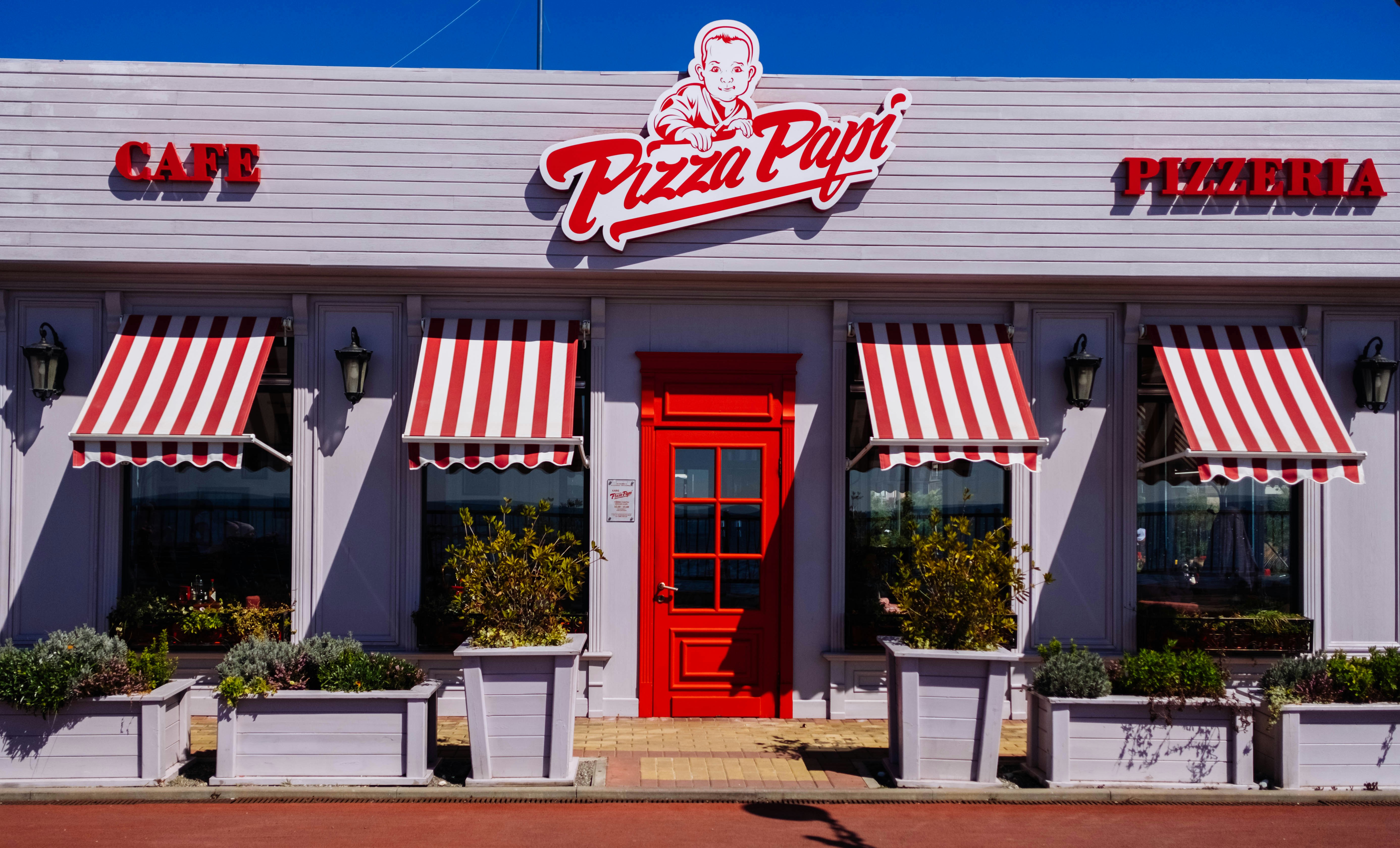White And Red Pizza Papi House With Closed Door Photo Free