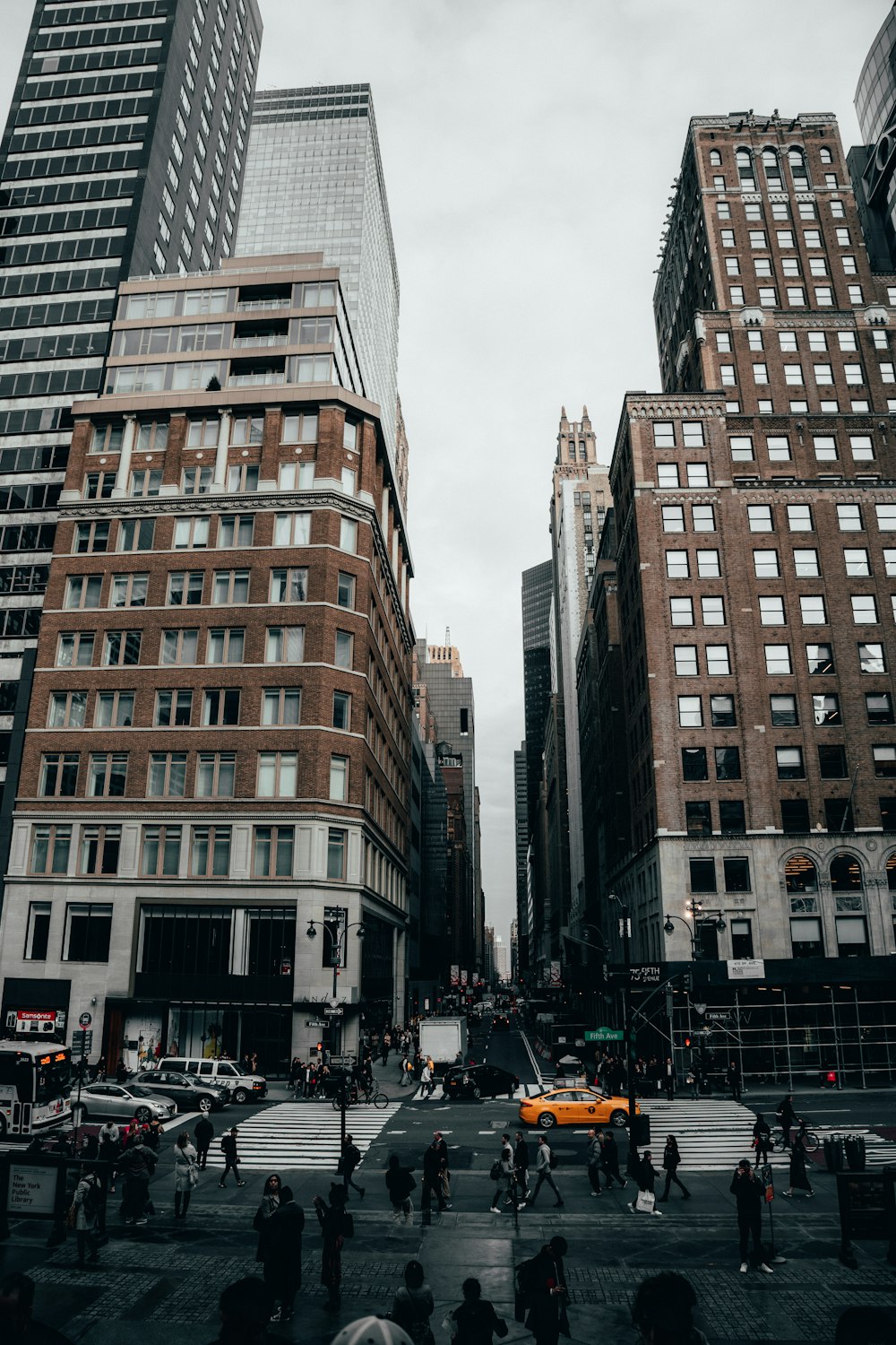 people walking on road near concrete buildings