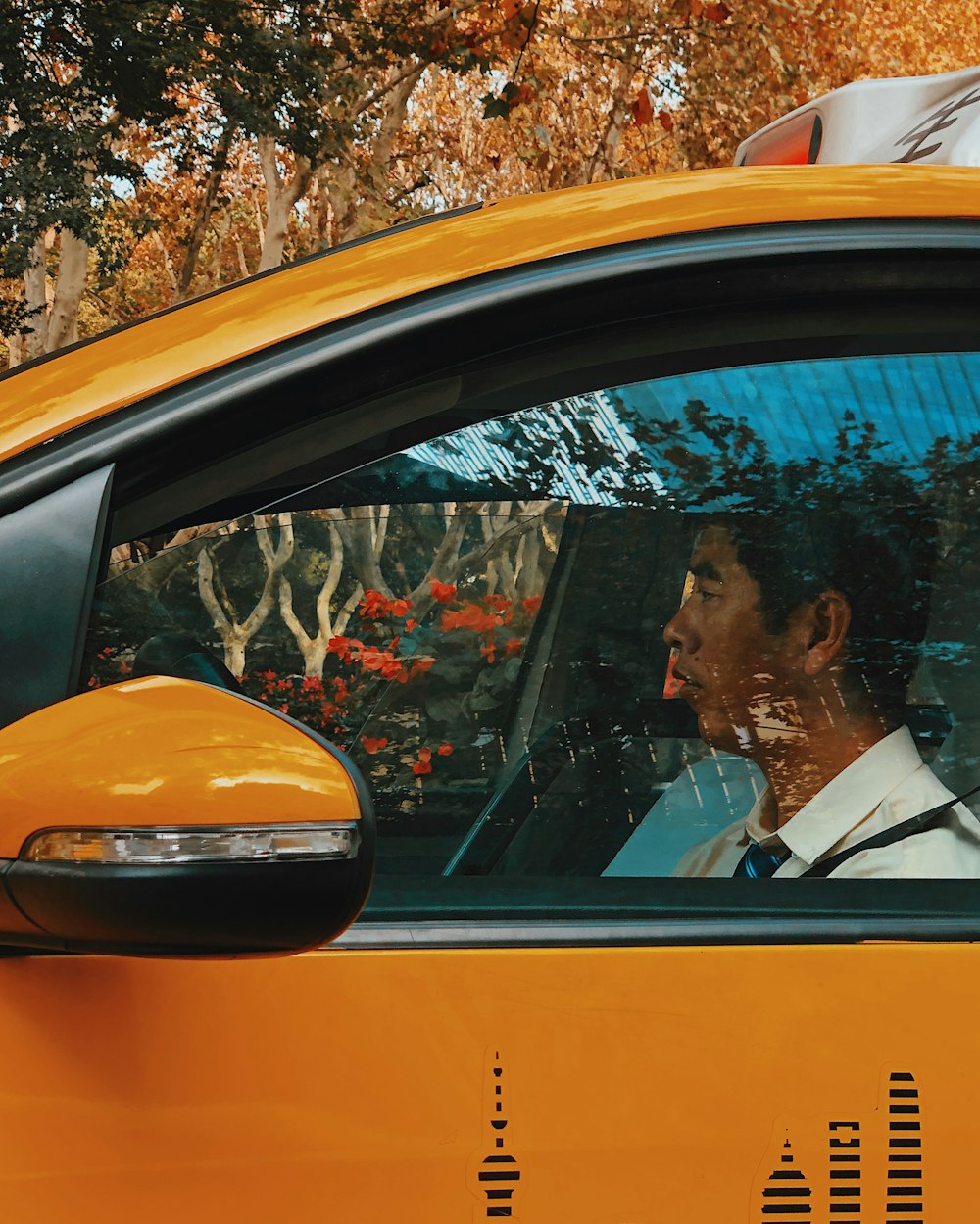 man driving yellow vehicle