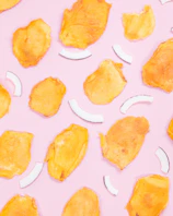 Premium dehydrated fruit snacks displayed in futuristic packaging with glowing pink and blue gradients.