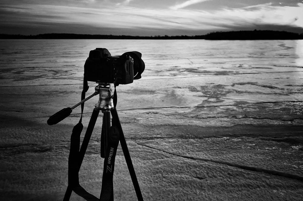 grayscale photo of camera near sea