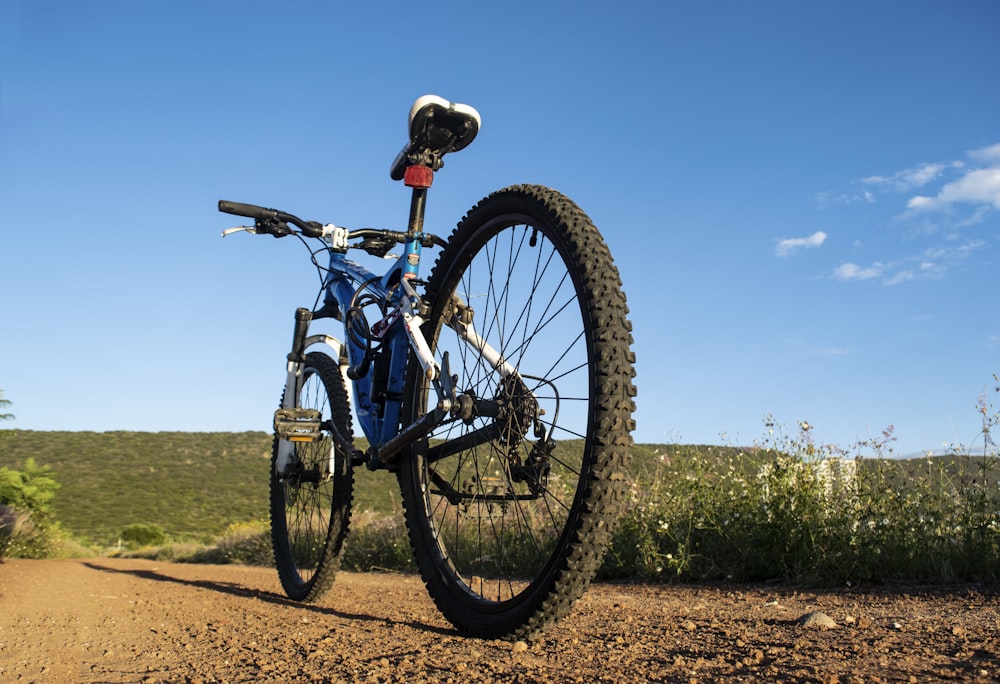 black mountain bike parked on road during daytime