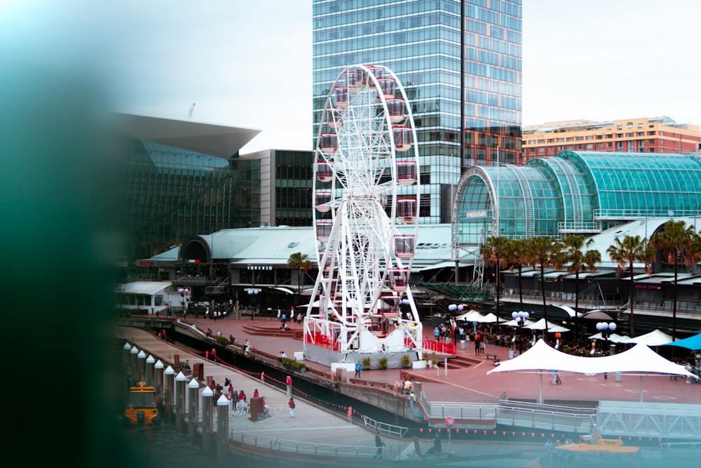 white Ferris wheel near building during daytime