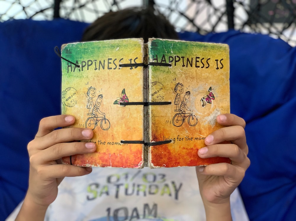 person reading happiness book