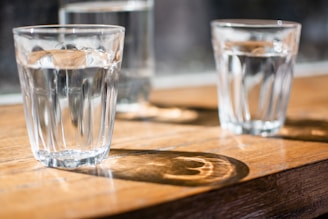 three clear drinking glass on table
