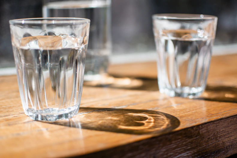 three clear drinking glass on table