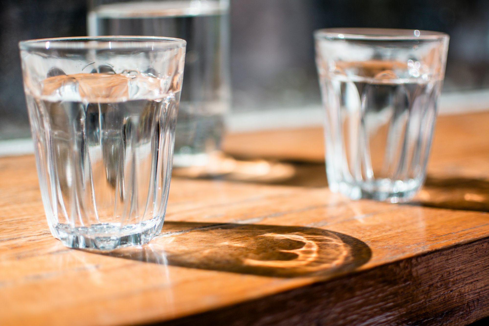 three clear drinking glass on table