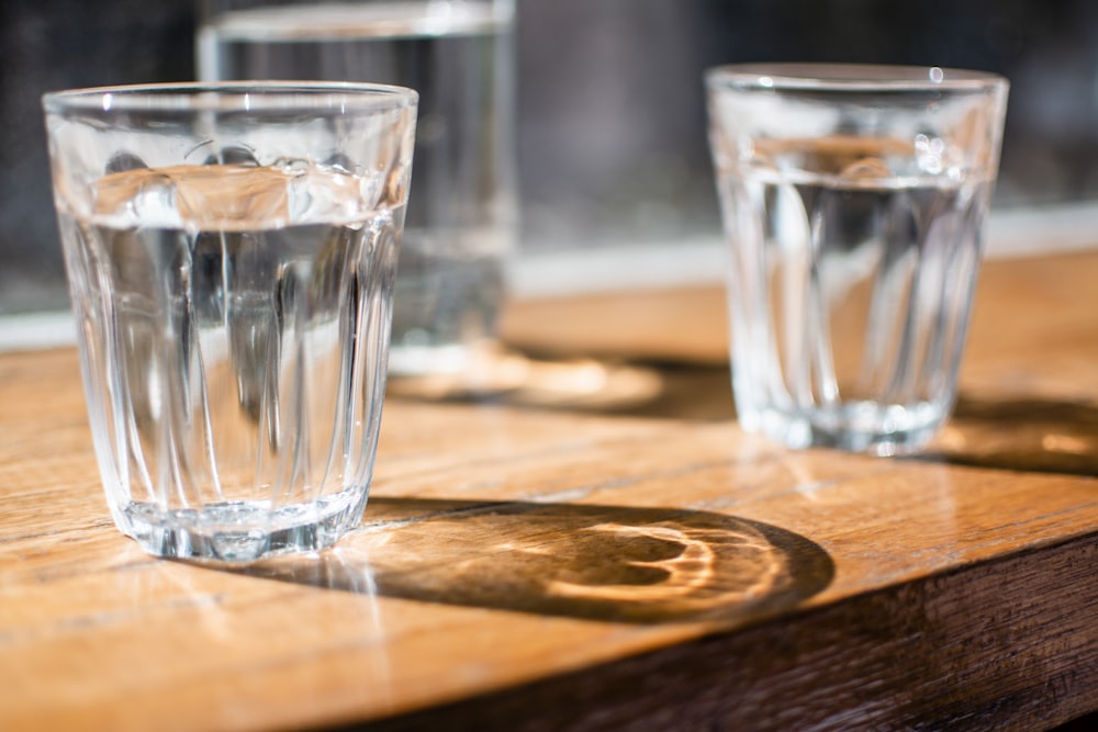 three clear drinking glass on table