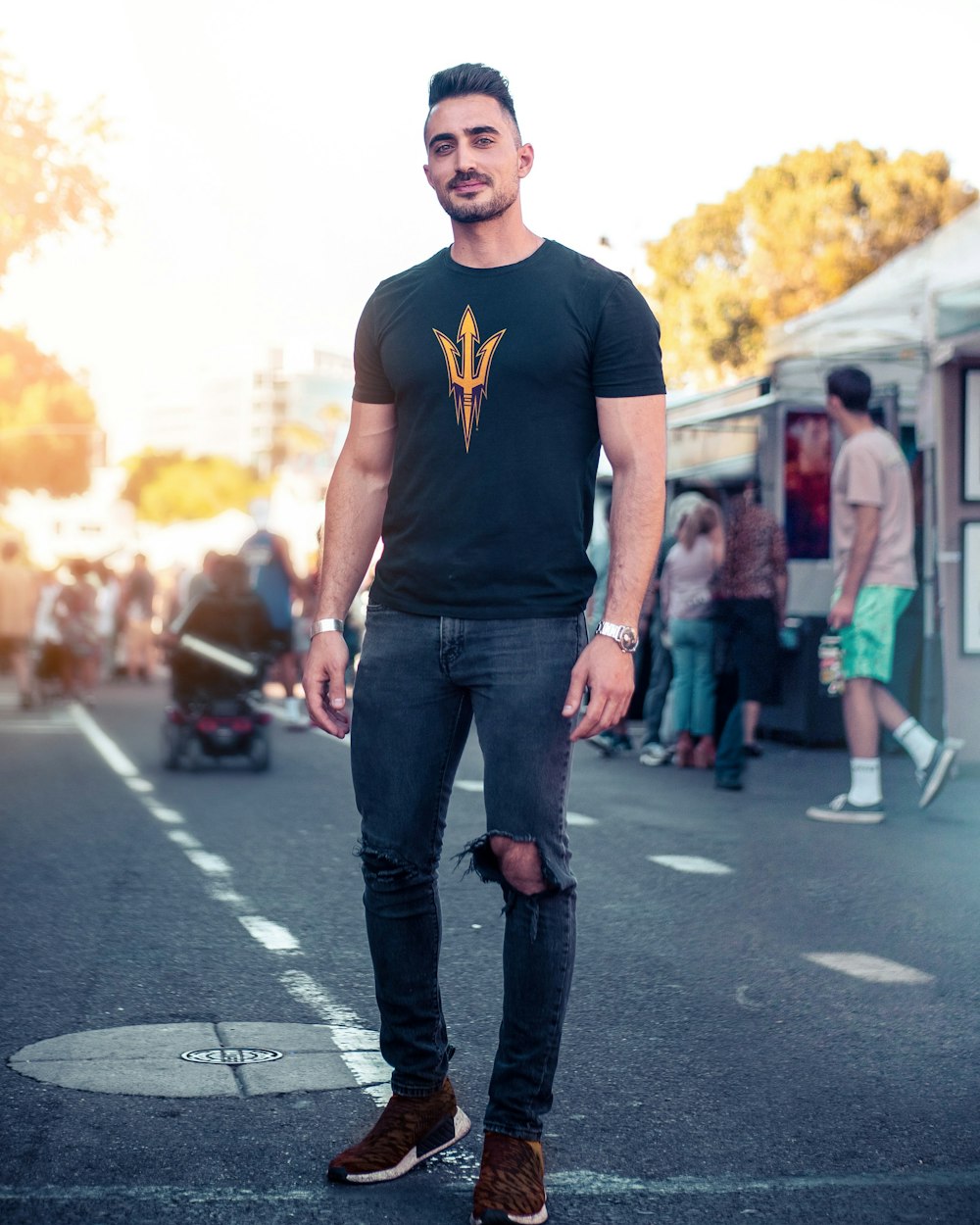 man wearing black and orange trident t-shirt