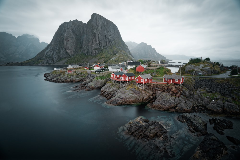 red and black houses beside sea