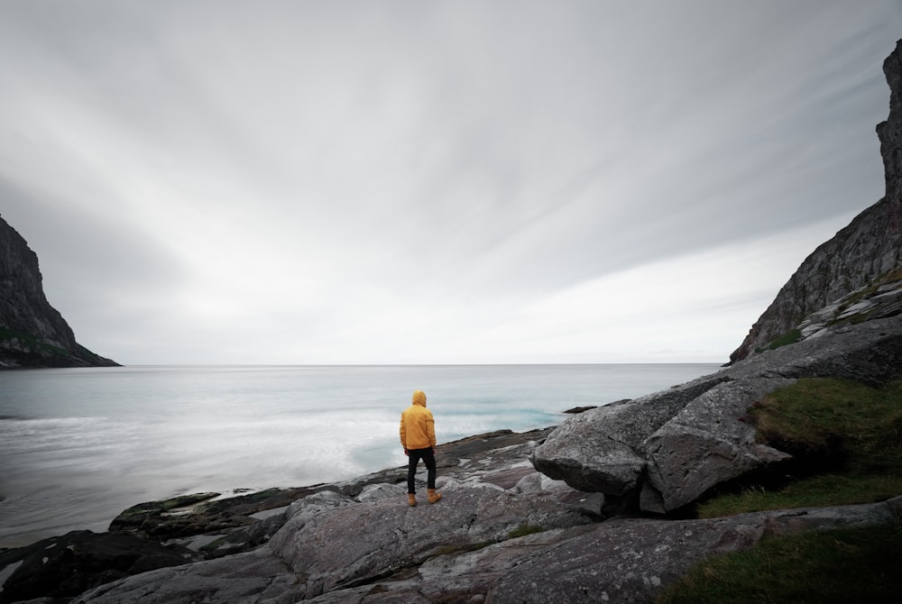 person standing on rock formation