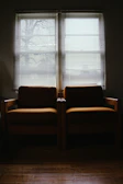 Two chairs facing each other in a quiet, inviting space.