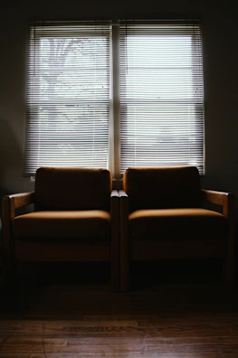 Two chairs facing each other in a quiet, inviting space.