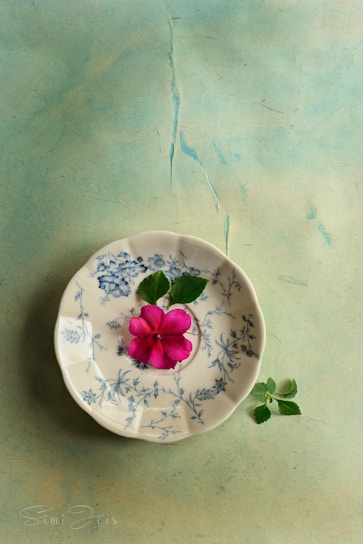 A delicate porcelain plate painted with soft floral motifs in pastel colors.