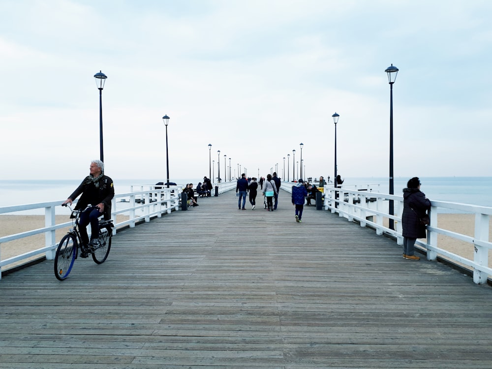 people walking on pier during daytime