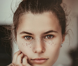 smiling woman holding cheek