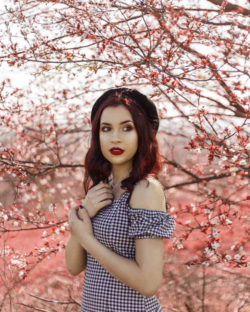 woman under red tree