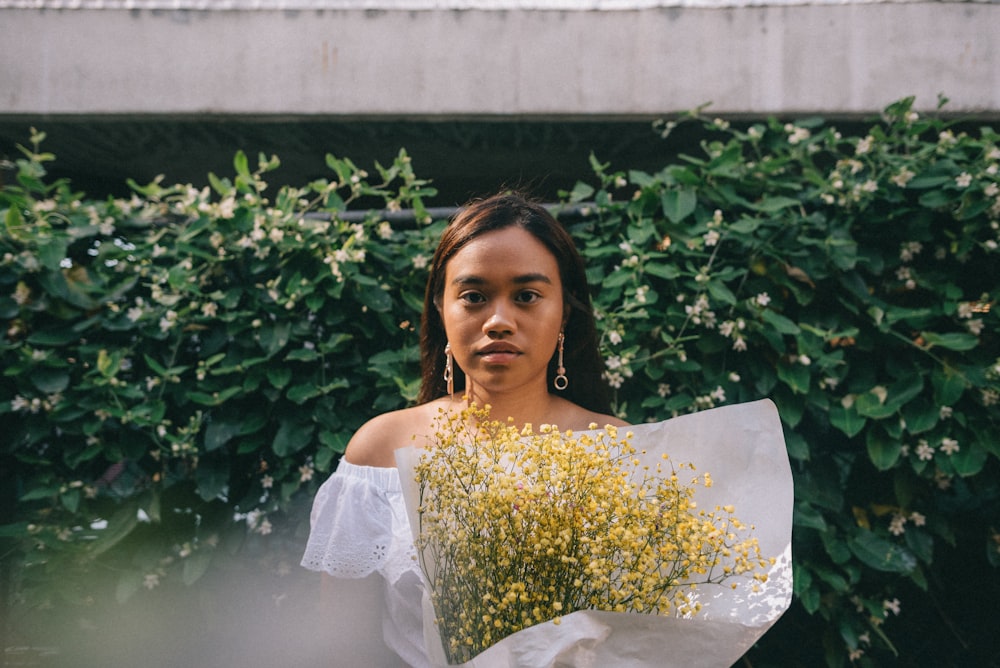 woman carrying bouquet of flowers