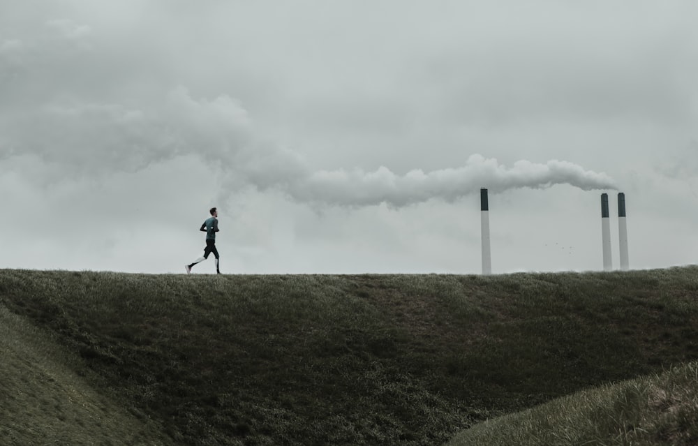 man running on grass field