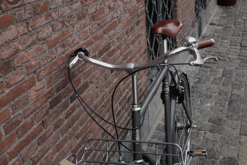 gray bicycle leaning on wall