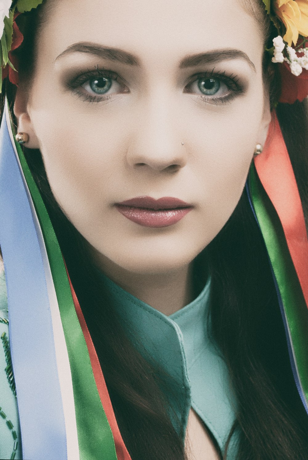 woman wearing gray top and multicolored headdress