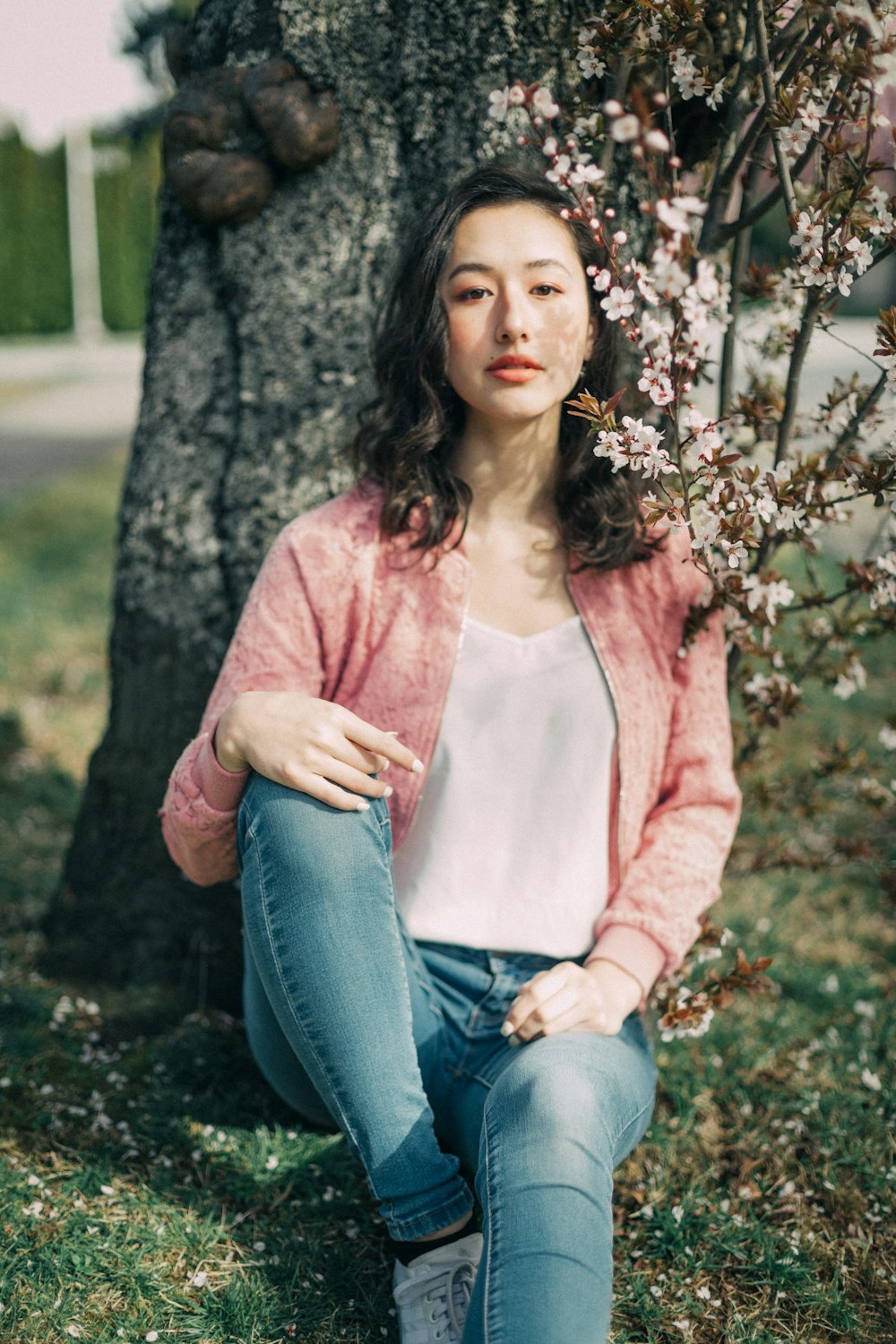 woman leaning on tree trunk